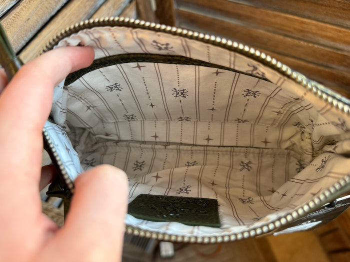 Olive mini wristlet bag interior with patterned lining and zip-top opening