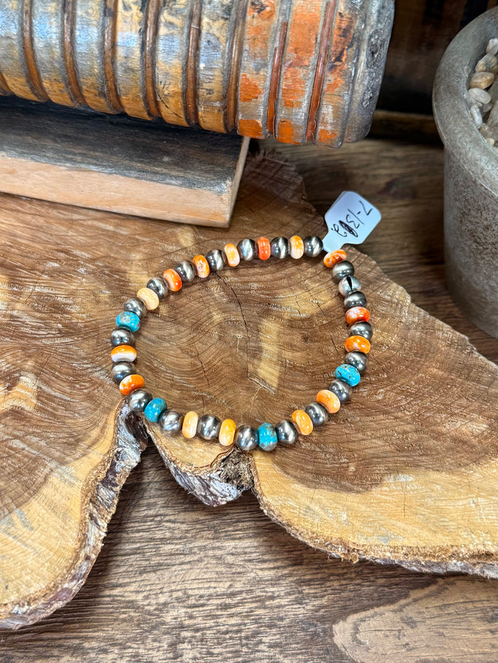 Stretch beaded bracelet with turquoise, orange, white shell pearls and silver spacers