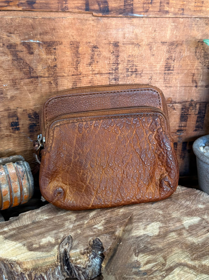 Brown cowhide double-zip coin wallet, front view with brass-toned zippers