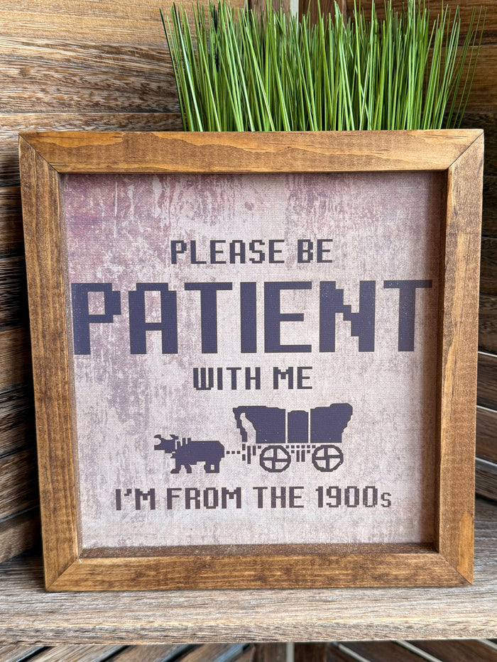 Wood framed wall art featuring “PLEASE BE PATIENT WITH ME” and farm-style icons