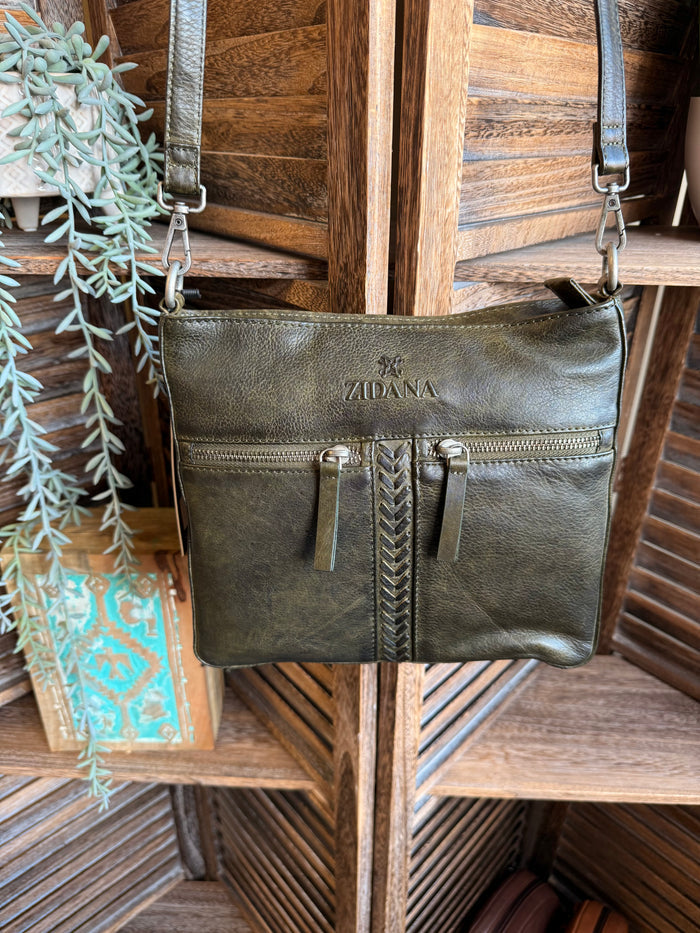 Olive leather crossbody bag with double front pockets and metal zipper, adjustable strap.