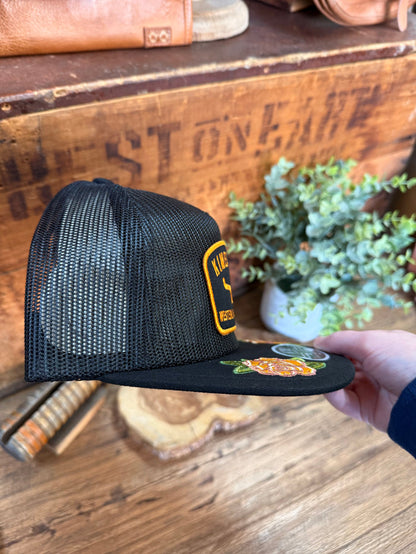 Black mesh baseball cap, side view with embroidered Kimes Ranch patch