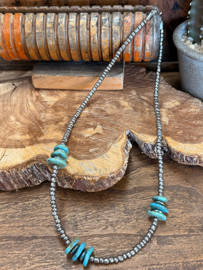 Turquoise and silver-tone beaded necklace with turquoise chunk accents and dangling strand