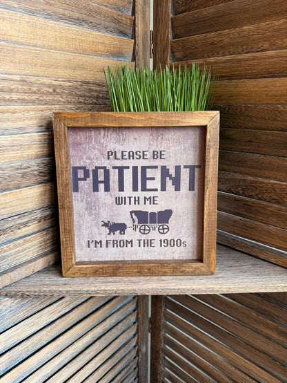 Wood framed wall art with “PLEASE BE PATIENT WITH ME” and “I'M FROM THE 1900s” text