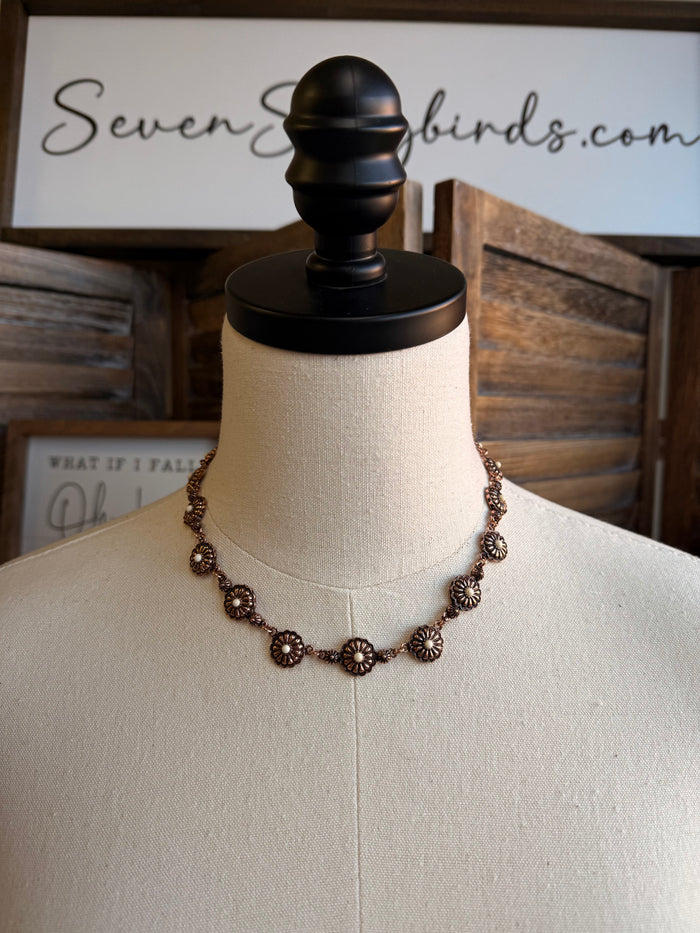 Copper-toned concho necklace with turquoise stone accents