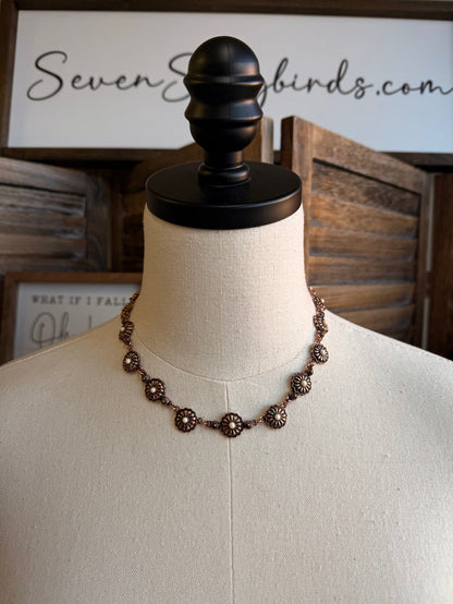 Copper-toned concho necklace with turquoise stone accents