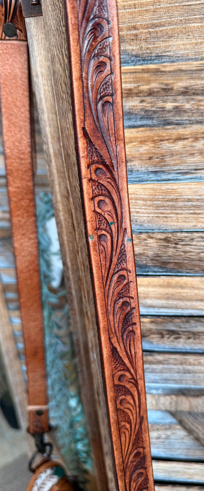 Embossed leather crossbody strap with carved decorative pattern