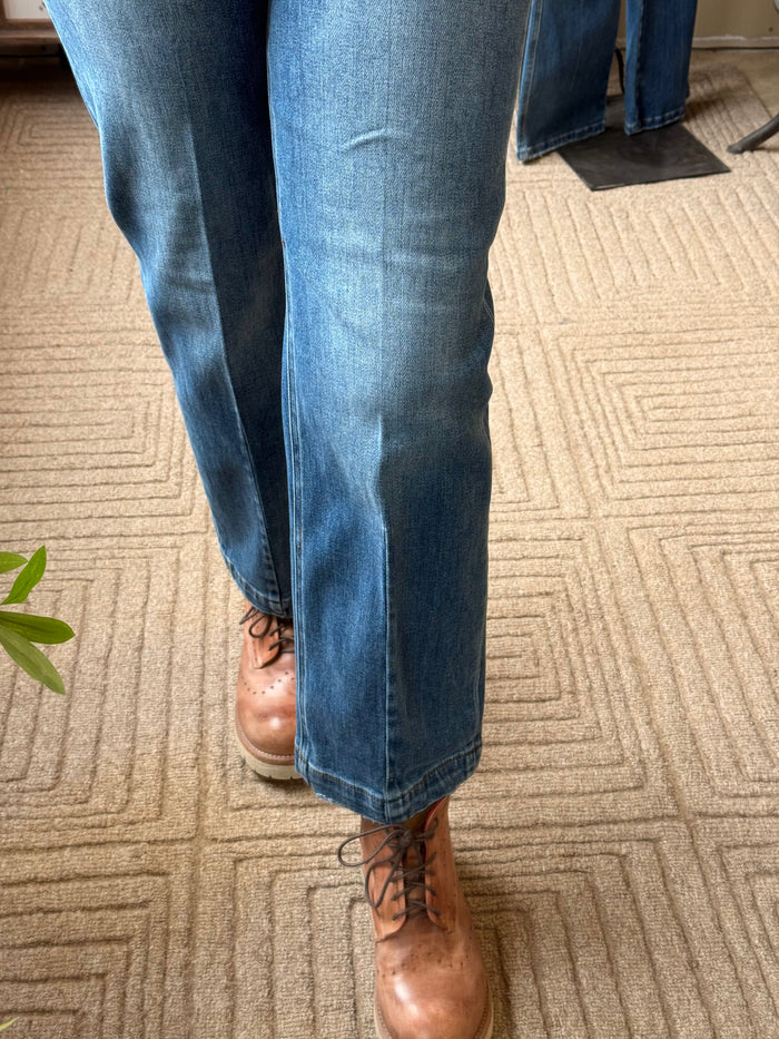 Cropped tapered jeans in medium-blue denim with cuffed ankle hem, front seam detailing