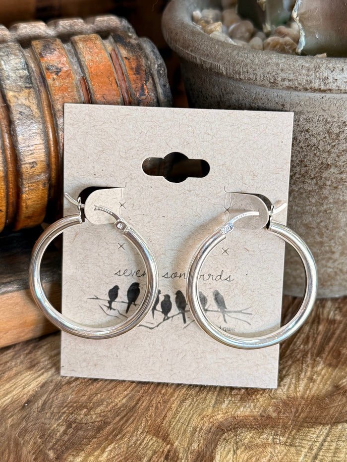 Sterling silver large round hoop earrings with bird motif on display card