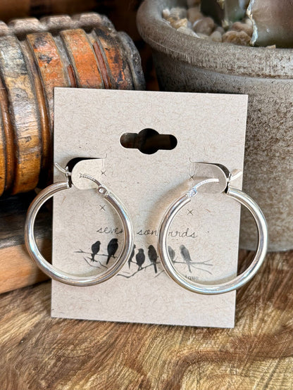 Sterling silver large round hoop earrings with bird motif on display card