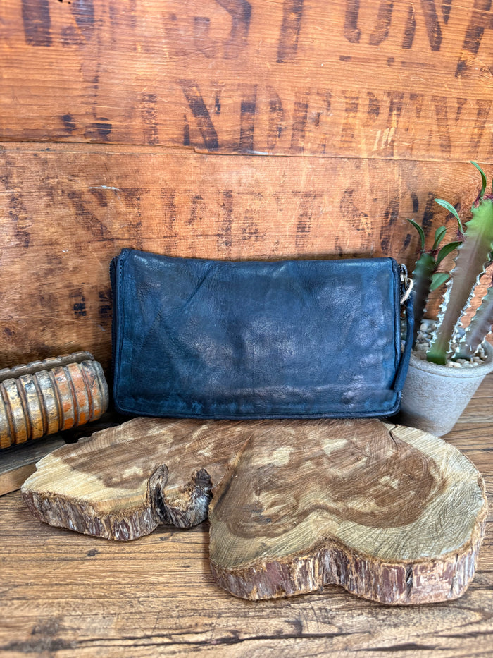 Navy leather zip-around wallet with curved zipper and front flap detail