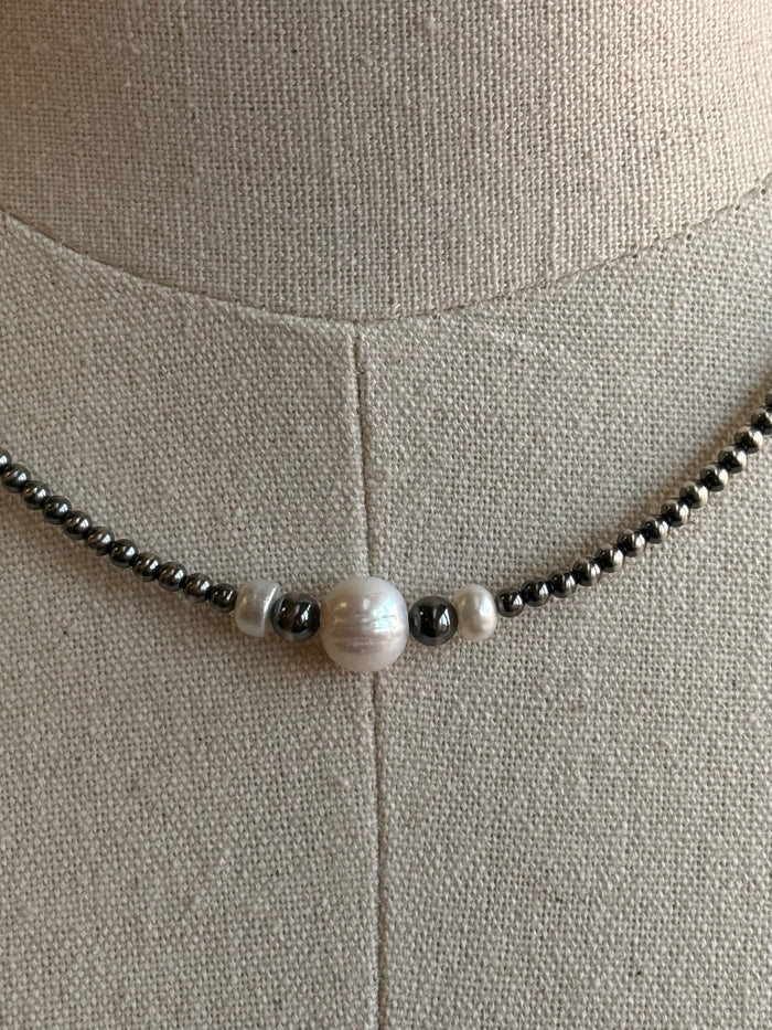 Freshwater pearl pendant bead with dark spacer beads on silver-toned chain