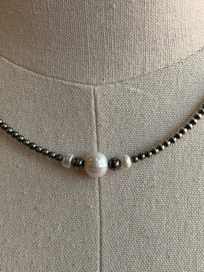Freshwater pearl pendant bead with dark spacer beads on silver-toned chain