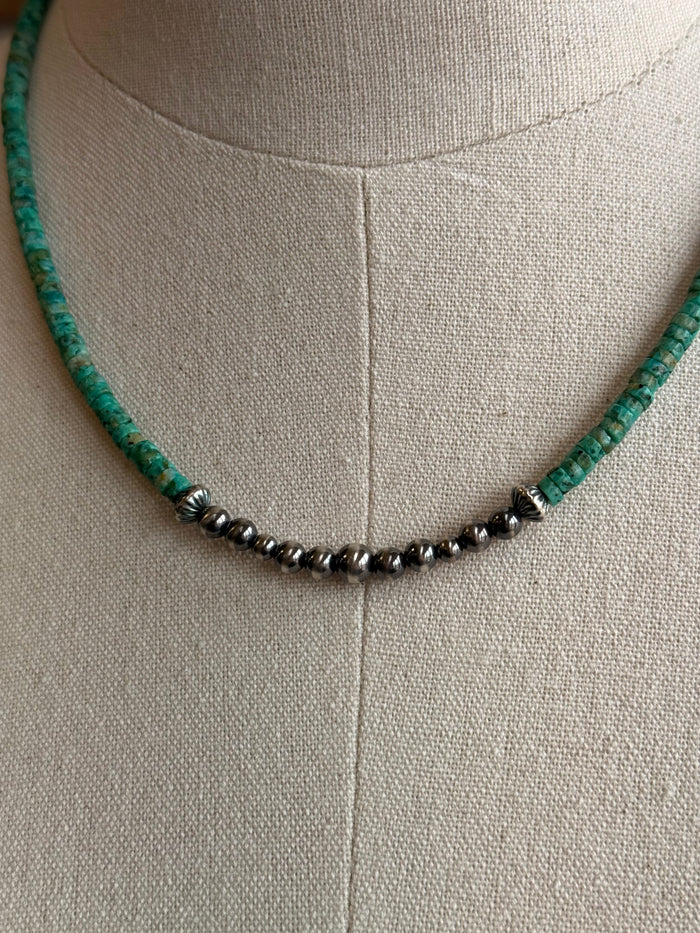 Close-up turquoise heishi with small sterling pearl beads along necklace