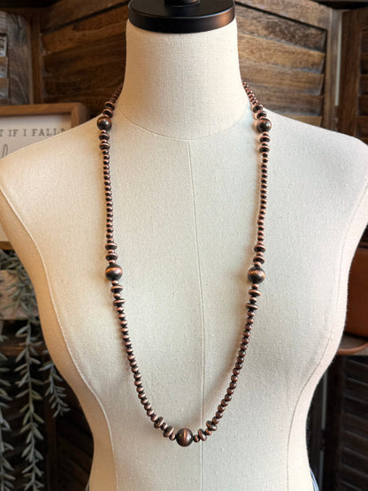 Copper pearl bead necklace with V-shaped drape and single continuous strand