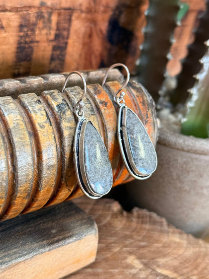 Pair of silver-tone teardrop stone fishhook earrings, angled view