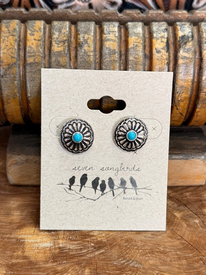 Silver-tone round turquoise concho stud earrings, centered on display card