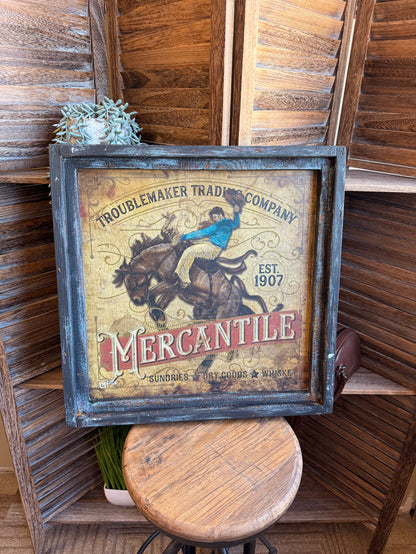 Vintage framed western artwork with blue rider on horse and 'Mercantile' text