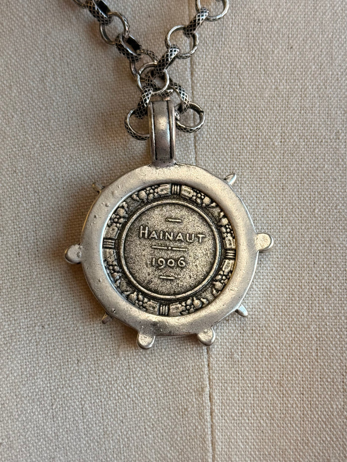 Round silver-tone medallion pendant back with 'Hainaut 1966' and chain