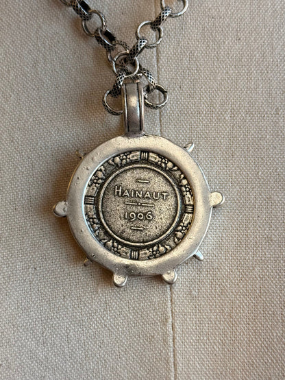 Round silver-tone medallion pendant back with 'Hainaut 1966' and chain