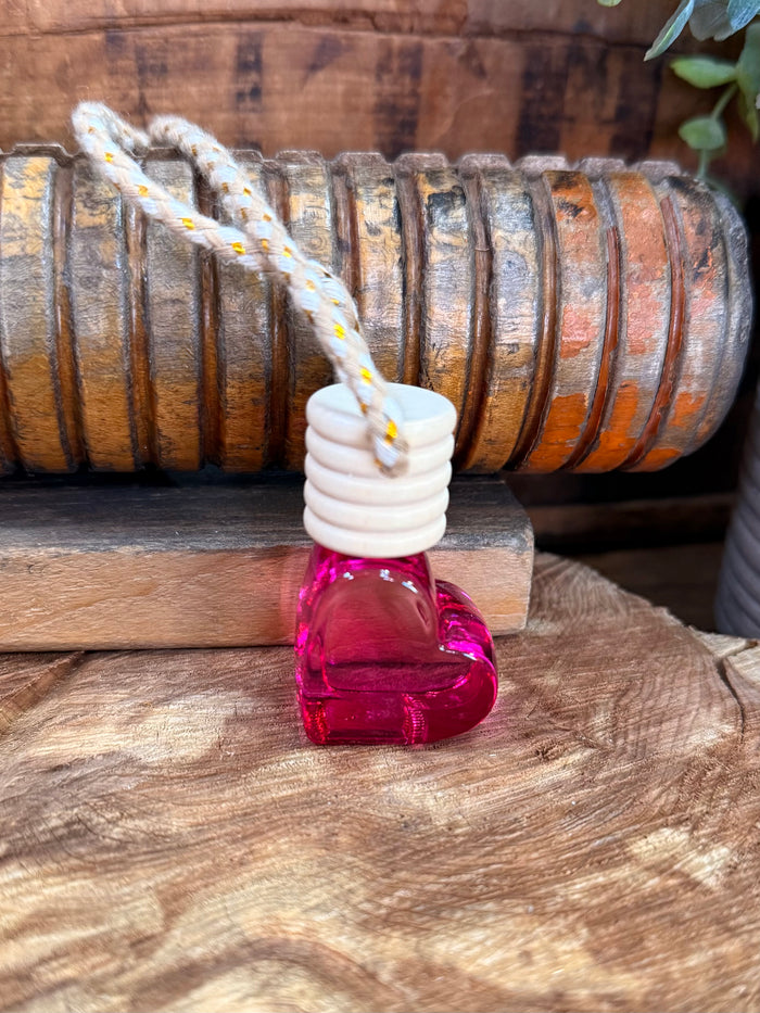 Heart-shaped scent diffuser bottle with pink glass and braided hanging loop