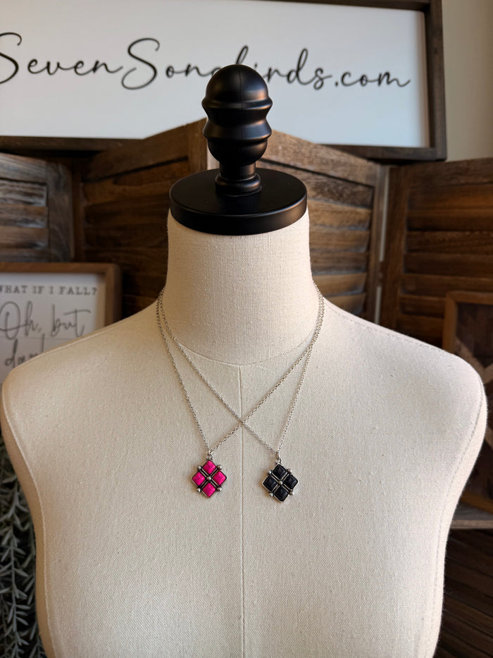 Diamond four-stone necklace with pink and black square pendants on silver chains