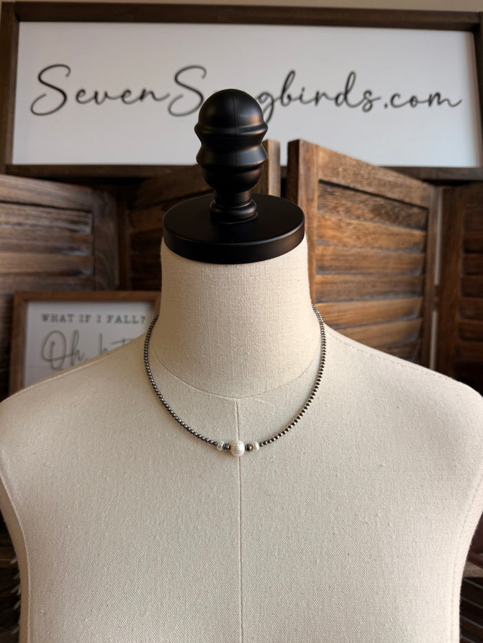 Freshwater pearl beaded necklace on mannequin, silver-toned chain with small gray beads