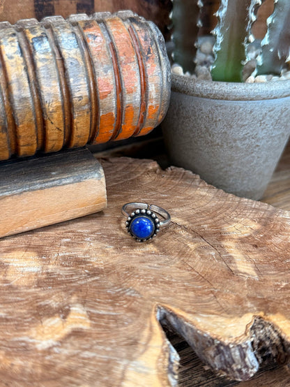 Adjustable silver-tone ring with round blue gemstone and bead-like border