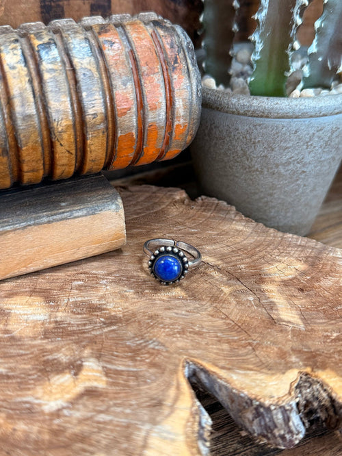 Adjustable silver-tone ring with round blue gemstone and bead-like border