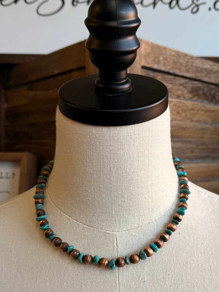 Copper and turquoise beaded necklace on mannequin, full neckline view
