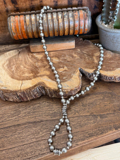 Pearl loop necklace with long beaded strand and dangling decorative bead charm