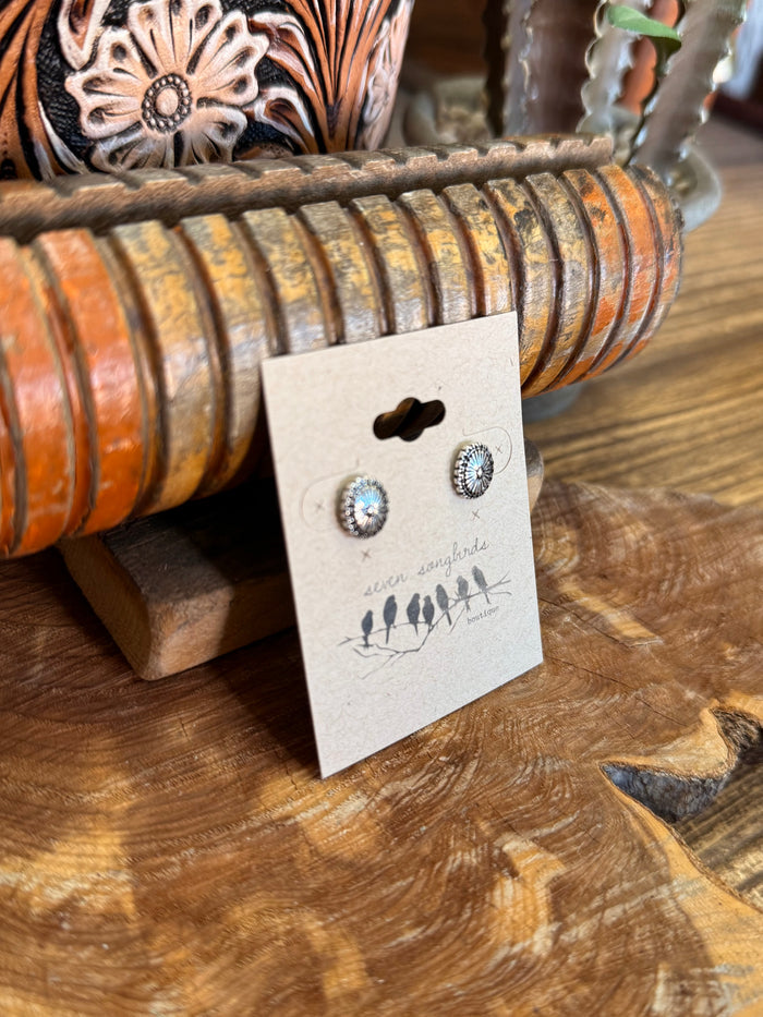 Silver concho stud earrings shown on a product display card