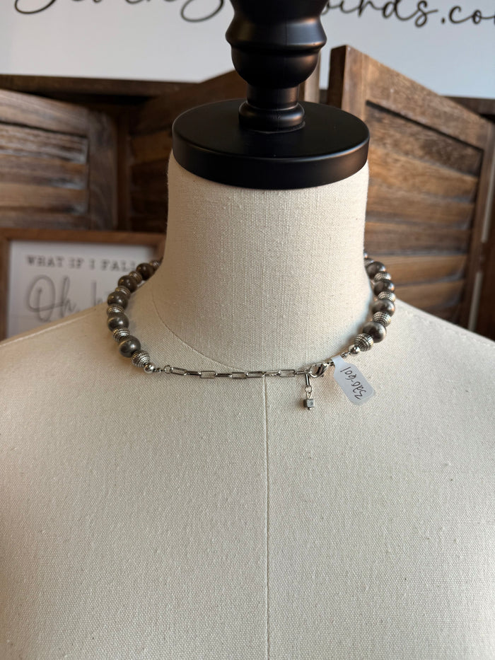 Silver pearl bead necklace with small dangling charm and black clasp