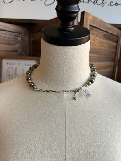 Silver pearl bead necklace with small dangling charm and black clasp