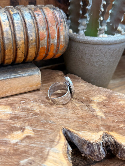 Adjustable silver-plated brass ring with oval stone, side view of the band