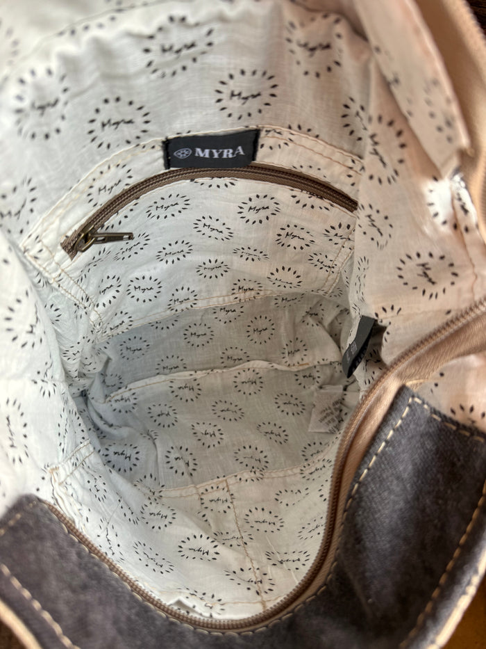 Canvas bag interior lining with MYRA logo badge and stitched seam details