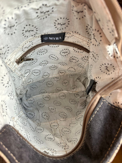 Canvas bag interior lining with MYRA logo badge and stitched seam details