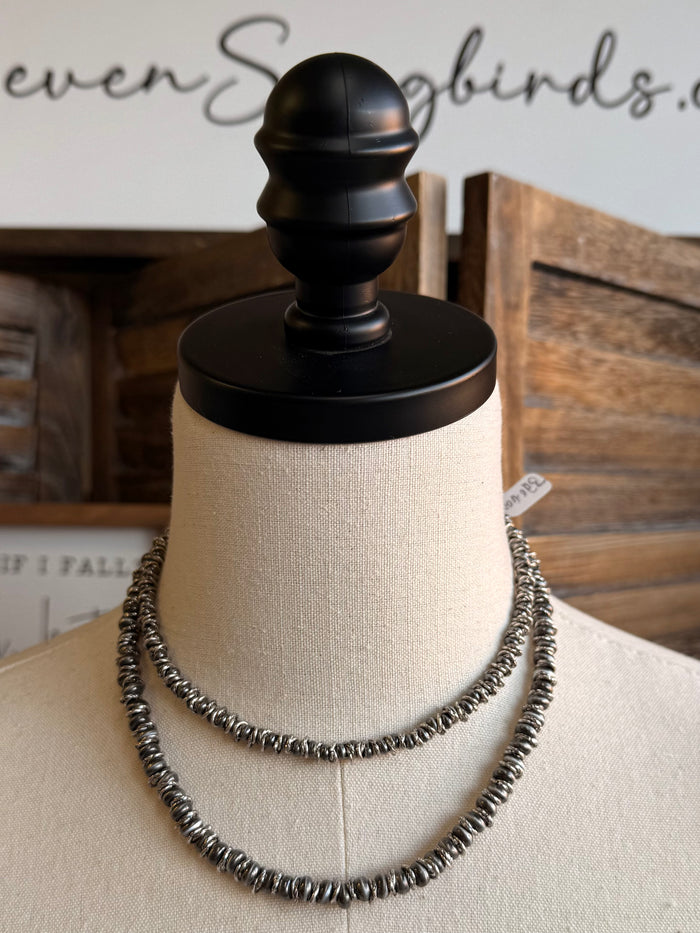 Silver pearl bead necklace with two stacked beaded rows on a mannequin bust