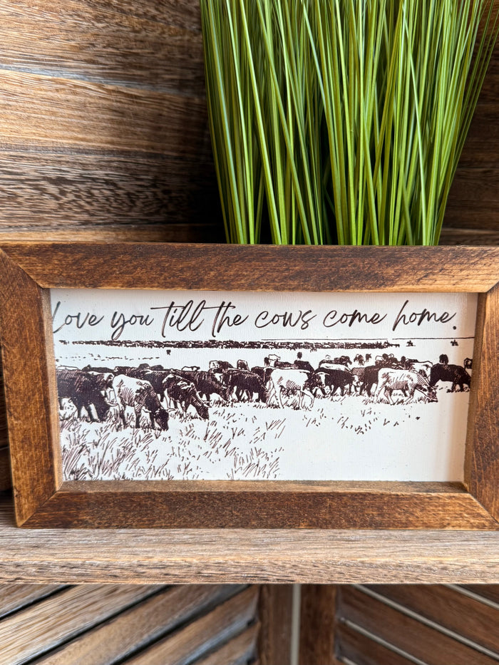 Rustic wood-framed cow herd print with cursive quote across the top