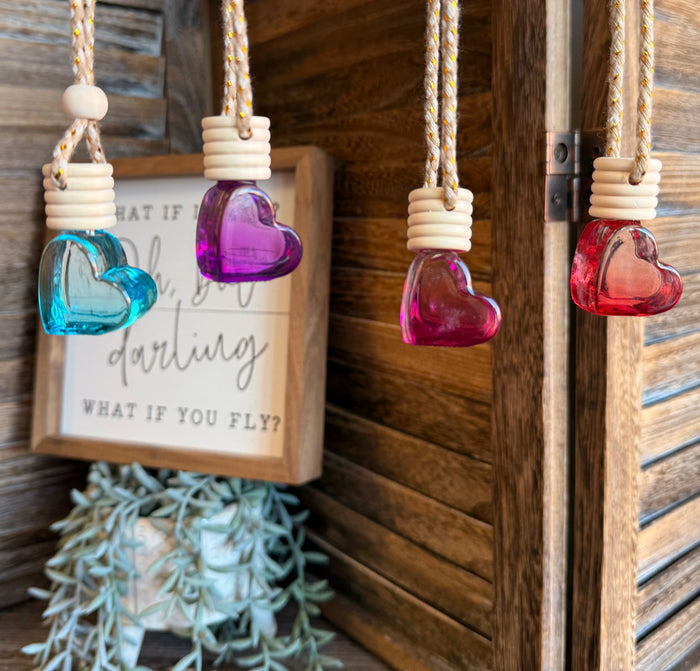 Heart-shaped scent diffuser bottle with purple glass and white ridged cap