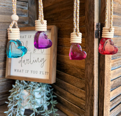 Heart-shaped scent diffuser bottle with purple glass and white ridged cap