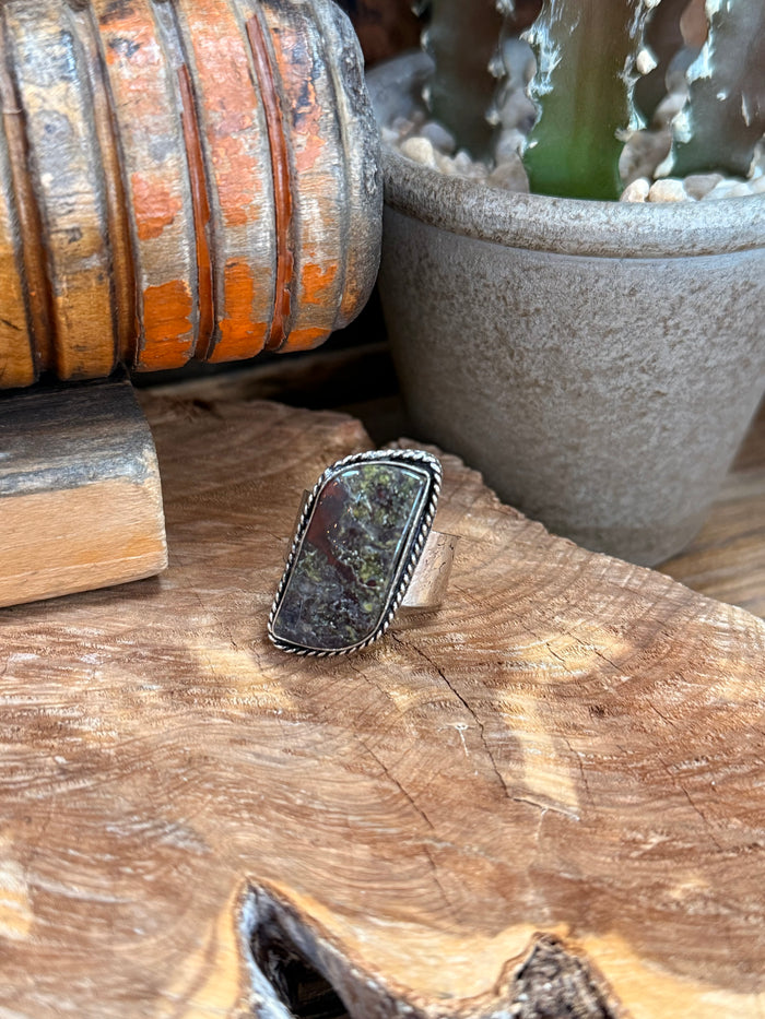 Dark multicolor stone cabochon ring with ornate silver-tone bezel