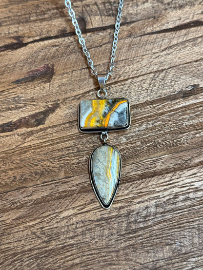 Silver lariat necklace with rectangular yellow-blue stone and teardrop pendant charm
