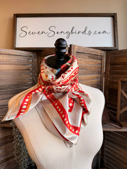 Red and white wild rag scarf with paisley border and cowboy boot print, draped