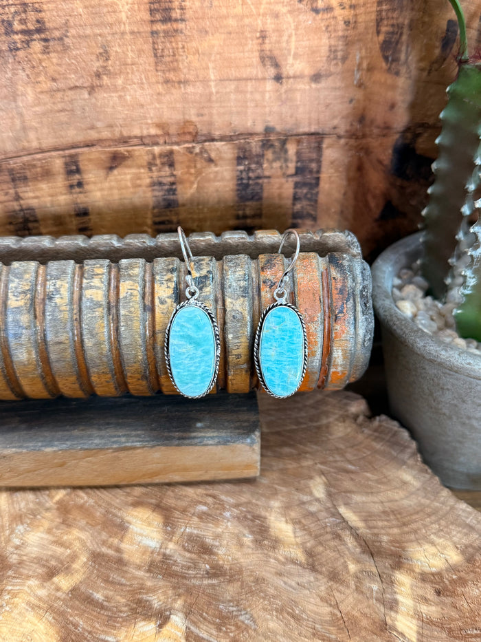 Silver fishhook earrings with oval sky-blue natural stone cabochons