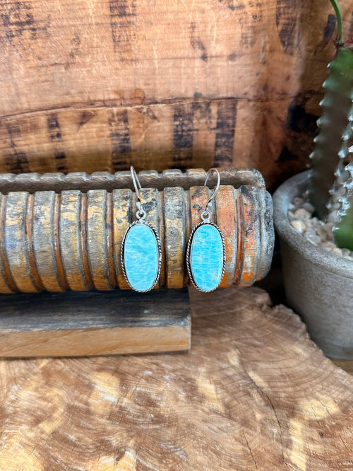 Silver fishhook earrings with oval sky-blue natural stone cabochons