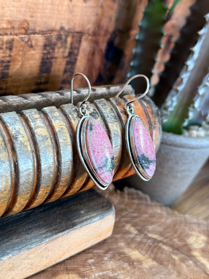 Silver-tone fishhook earrings with pink oval rhodonite stone and side view