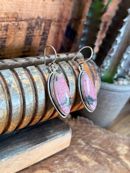 Silver-tone fishhook earrings with pink oval rhodonite stone and side view