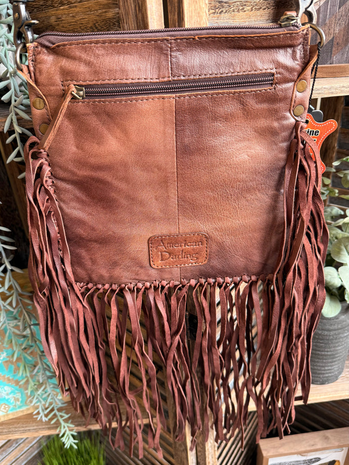 Leather fringed crossbody coin purse with embossed patch, zipper top, and dangling tassels