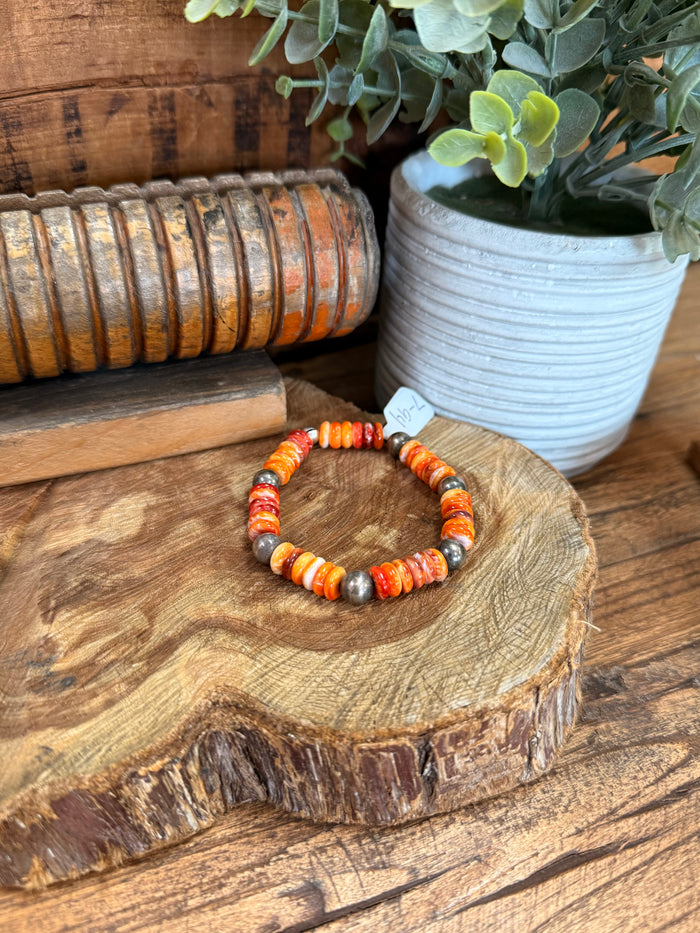Beaded stretch bracelet with orange and white spiny oyster-style beads, silver spacer beads